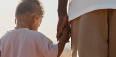 back-view-portrait-cute-africanamerican-toddler-holding-hands-with-dad-while-enjoying-walk-bea-scaled-1-300x200