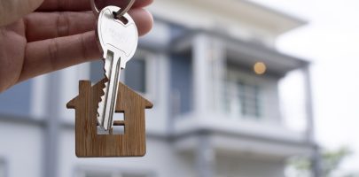 Landlord unlocks the house key for new home.  Real Estate Agents, Sales Agents concept.